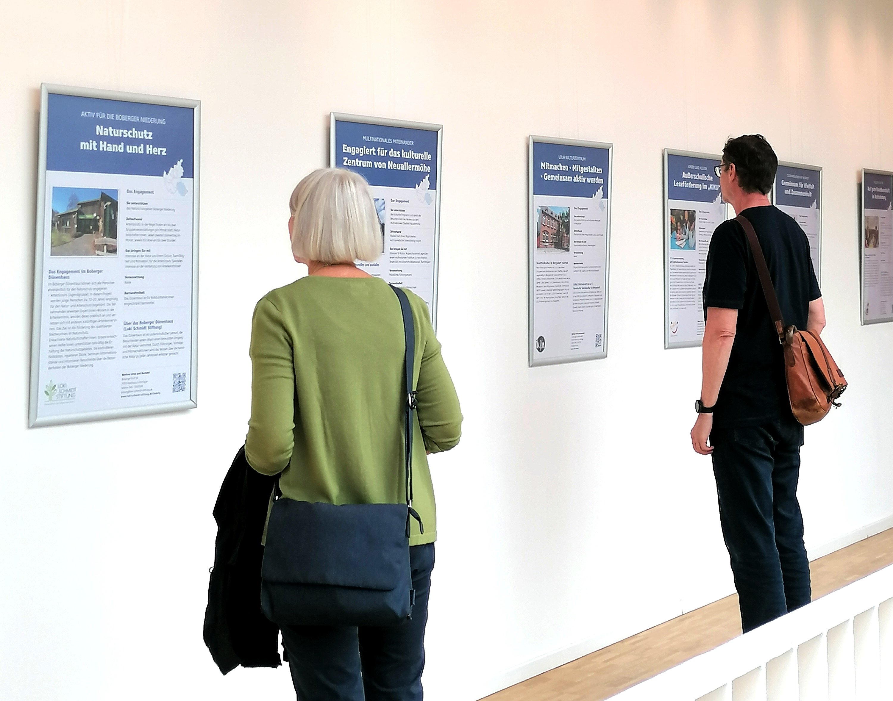 Menschen betrachten die Ausstellung "Bergedorf engagiert sich"
